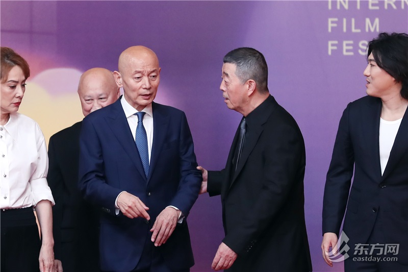 电影《刺猬》剧组导演顾长卫、演员葛优在红毯等候区交谈