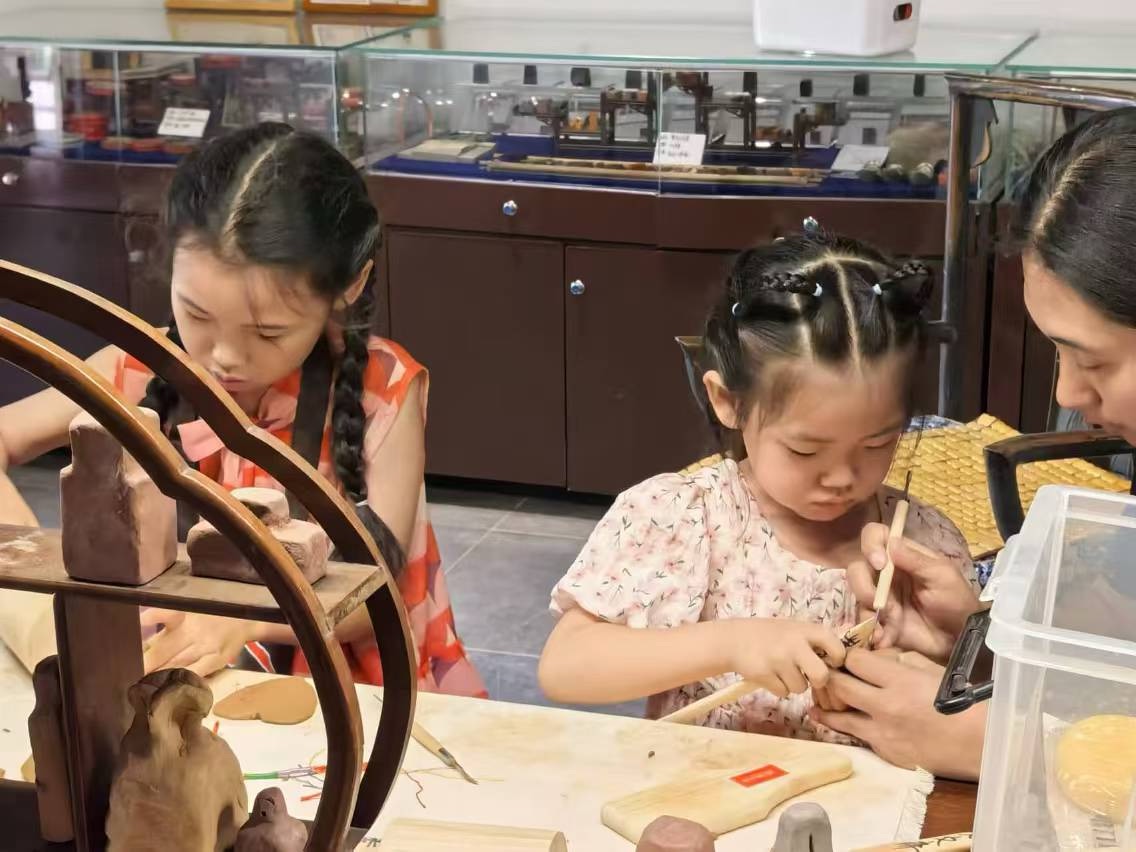 ▲孩子们正在秀文斋·花印小院非遗工坊进行体验